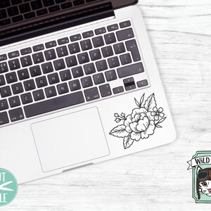 May include: A black and white line drawing of a floral bouquet with a laptop computer in the background. The image also includes a pink circle with the word "png" in black text.