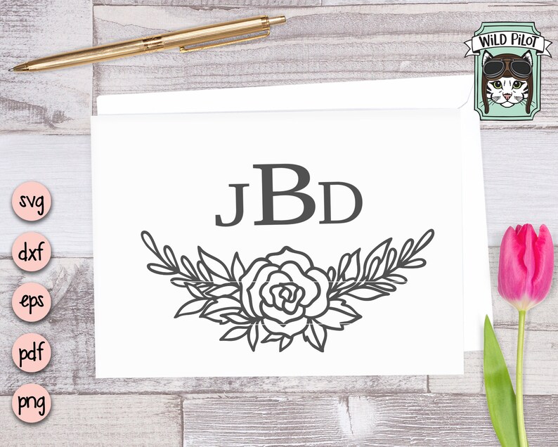 May include: A black and white monogram design with the letters "JBD" surrounded by a floral wreath. The wreath is made up of leaves and a single rose.