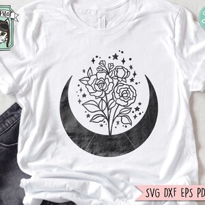 May include: A black and white graphic design of a crescent moon with a bouquet of roses inside. The moon has a textured look and the roses are stylized.