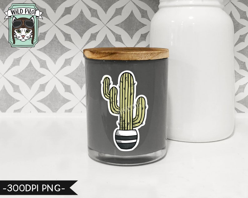 May include: A gray candle jar with a wooden lid and a cactus sticker on the front. The sticker features a green cactus in a black and white striped pot.