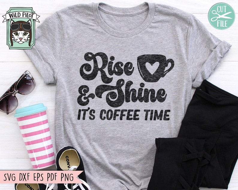 May include: A gray t-shirt with a black graphic that says "Rise & Shine It's Coffee Time". The graphic includes a stylized coffee cup with a heart.