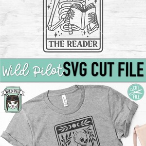 May include: A grey t-shirt with a black and white tarot card design. The card shows a skeleton reading a book, with the words "THE READER" at the bottom. The image also includes the text "Wild Pilot SVG CUT FILE".