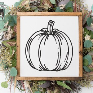 May include: A black and white line drawing of a pumpkin on a white background. The pumpkin is in the center of the image and is surrounded by a wooden frame.