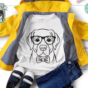 May include: A black and white illustration of a dog wearing glasses and a bow tie. The image is on a white t-shirt, which is folded and laid on a yellow jacket and blue jeans. The image is for a digital download and includes the file types: SVG, DXF, EPS, PDF, and PNG.