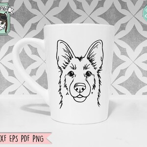 May include: A white ceramic mug with a black and white line drawing of a German Shepherd dog's head. The dog is looking directly at the viewer.