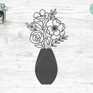May include: A black vase with a simple design holds a bouquet of white flowers with black outlines. The flowers have a delicate, feminine look.