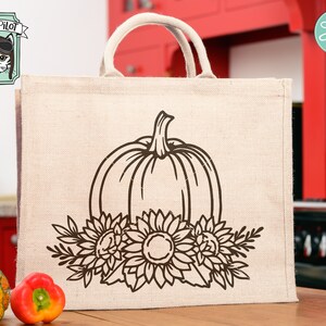 May include: A brown burlap tote bag with a black outline of a pumpkin and sunflowers. The text "Wild Pilot" is in the top left corner of the image.