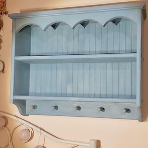 s92 Solid timber cottage style cabinet with wavy top moulding and pegs