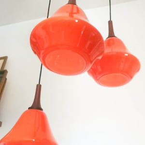Vintage scandinavian chandelier with three lights orange glass pendants design 1970&#39;s teck and bronze mount