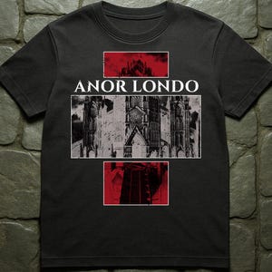 May include: Black t-shirt featuring the text "ANOR LONDO" above a grayscale image of a cathedral. The design includes red rectangular accents with architectural elements, creating a gothic aesthetic.