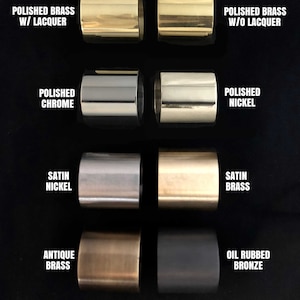 May include: Close-up of eight metal cylinders in different finishes, including polished brass with and without lacquer, polished chrome, polished nickel, satin nickel, satin brass, antique brass, and oil rubbed bronze.