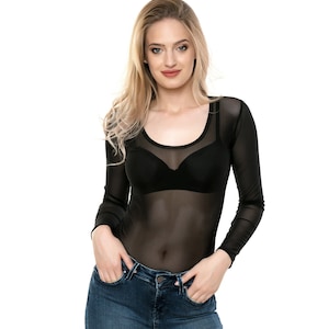 May include: A black sheer long-sleeved top with a scoop neck. The top is worn over a black bra.