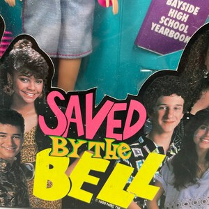 May include: A colorful box featuring the cast of the television show "Saved by the Bell". The box has a pink and yellow logo with the words "Saved by the Bell" and the copyright information "&copy;1990 NBC TM".