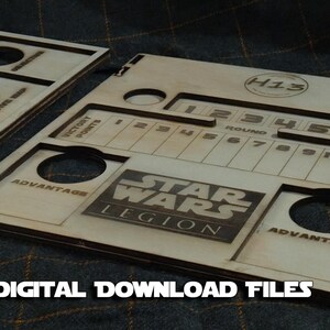 May include: A wooden game organiser for Star Wars: Legion, featuring a numbered grid, two advantage tokens, and a compartment for character cards. The organiser is labelled "H13" and "Star Wars Legion".