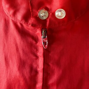 May include: A trio of cream-glazed ceramic mugs, each adorned with a hand-painted floral pattern. The designs feature blue, green, and yellow hues. The mugs have a classic, rounded form.