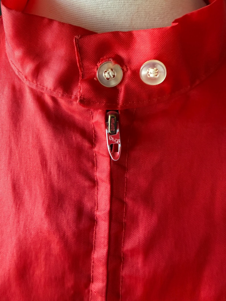 May include: A trio of cream-glazed ceramic mugs, each adorned with a hand-painted floral pattern. The designs feature blue, green, and yellow hues. The mugs have a classic, rounded form.