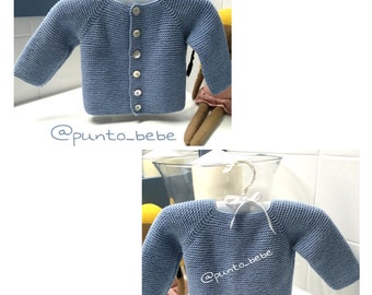 May include: A light blue knitted baby cardigan with a button closure. The cardigan is shown hanging on a hanger and on a doll. The text '@punto_bebe' is visible on the image.