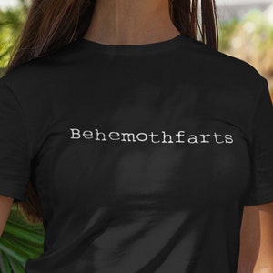 May include: A black t-shirt with the text "Behemothfarts" printed in white on the front.