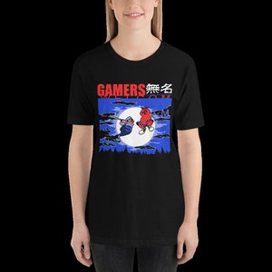 May include: Black t-shirt with a graphic of two cartoon characters in front of a moon. The text "GAMERS 無名" is printed in red on the shirt.