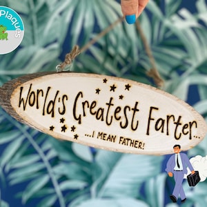 May include: A wooden plaque with the text "World's Greatest Farter... I mean Father!"  The plaque is oval shaped and has a rustic wood grain. It is hanging from a string. A cartoon man in a suit is walking away from the plaque with a cloud of smoke behind him.