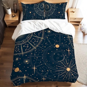 May include: A navy blue celestial-themed bedding set featuring a duvet cover and two pillowcases. The design includes gold constellations, zodiac symbols, planets, and a crescent moon. The bedding is on a wooden bed frame with matching nightstands.