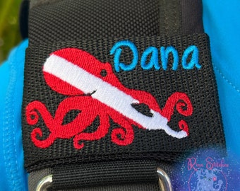 May include: Black scuba diving octopus patch with a white and red dive flag and the name "Dana" embroidered in blue.