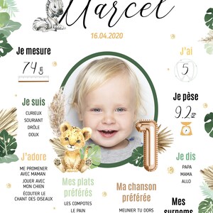 May include: A green and white illustrated poster with a photo of a baby boy. The poster includes information about the baby's age, weight, height, favorite foods, songs, and nicknames. The poster is decorated with jungle animals, including a zebra, lion, giraffe, and a number one balloon.