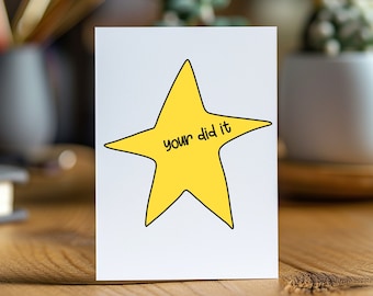 May include: A white card with a yellow star and the text "you did it" in black.