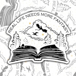 May include: A black and white sticker with a book opening to reveal a forest scene with clouds and flying bats. The text around the book reads "Real Life Needs More Fantasy".