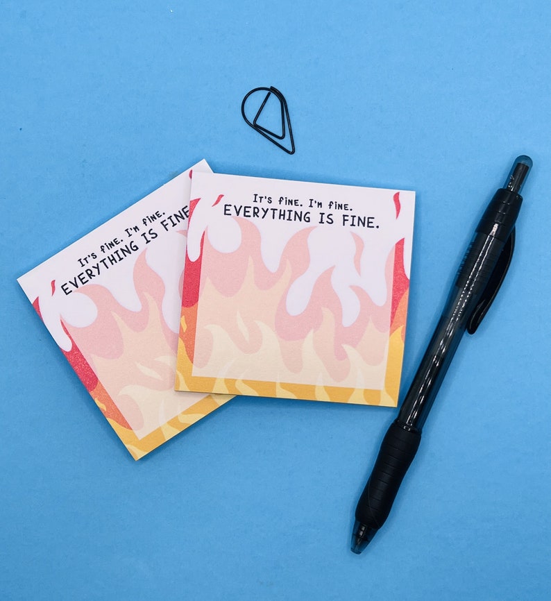 May include: Two yellow sticky notes with a fire design and the text "It's fine. I'm fine. Everything is fine." on a blue background.