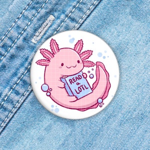 May include: A pink axolotl cartoon character holding a blue book that says "Read a Lotl" on a white background.