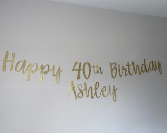 May include: Gold glitter banner with the text "Happy 40th Birthday Ashley".