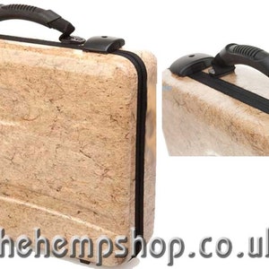 May include: A beige suitcase with a black handle and black accents. The suitcase is made of a textured material that resembles hemp.