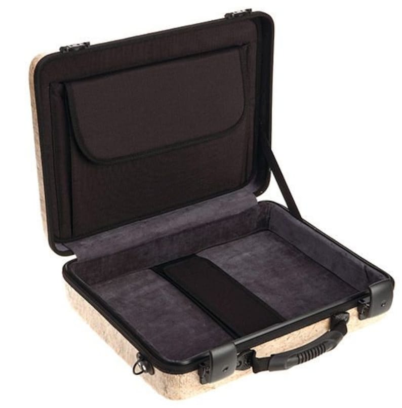 May include: A beige hard-shell case with a black interior and a zippered pocket. The case has a handle and a latch.