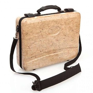 May include: A beige hard-shell case with a black carrying strap. The case has a textured surface and a black handle.