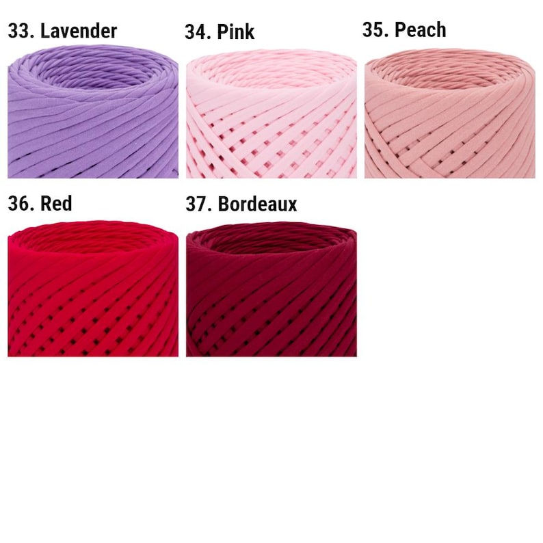 May include: Close-up of five spools of yarn in different colors: lavender, pink, peach, red, and burgundy. The yarn is thick and textured, with a woven pattern.