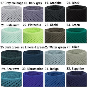 May include: A collection of 16 yarn skeins in various colors, including gray, green, blue, and purple. The yarn is arranged in four rows of four skeins each. Each skein is labeled with a number and a color name.