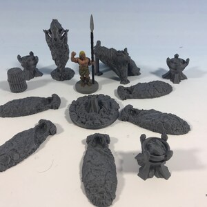 May include: A set of 3D printed miniature dungeon pieces, including a campfire, a figure, and several stone structures.