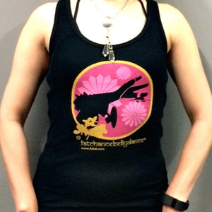 May include: Black tank top with a pink and gold circle design featuring a silhouette of a dancer. The text "fatchancebellydance" and "www.fbdd.com" is printed below the circle.