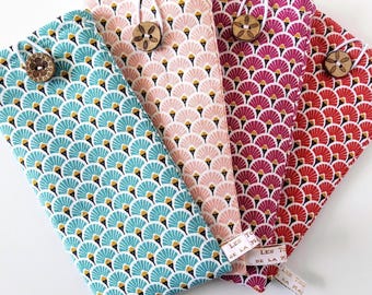 May include: Four fabric cases with fan-shaped patterns in teal, pink, burgundy, and red. Each case has a wooden button closure and a white tag with gold text. The cases are folded and arranged to display their colorful designs.