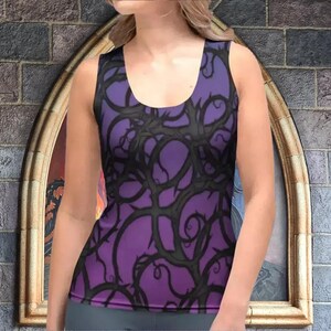 a woman wearing a purple top with a castle in the background