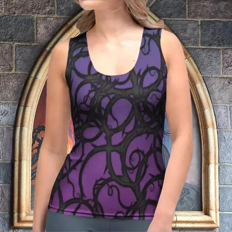 a woman wearing a purple top with a castle in the background