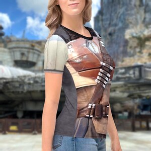 A woman wearing a t-shirt with a printed design of a character from a television series or movie.