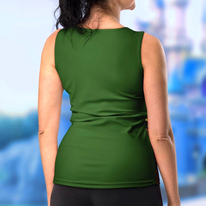 a woman in a green top is standing in front of a castle