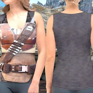 A woman wearing a tank top with a detailed design, including a belt and straps, against a rocky landscape background.