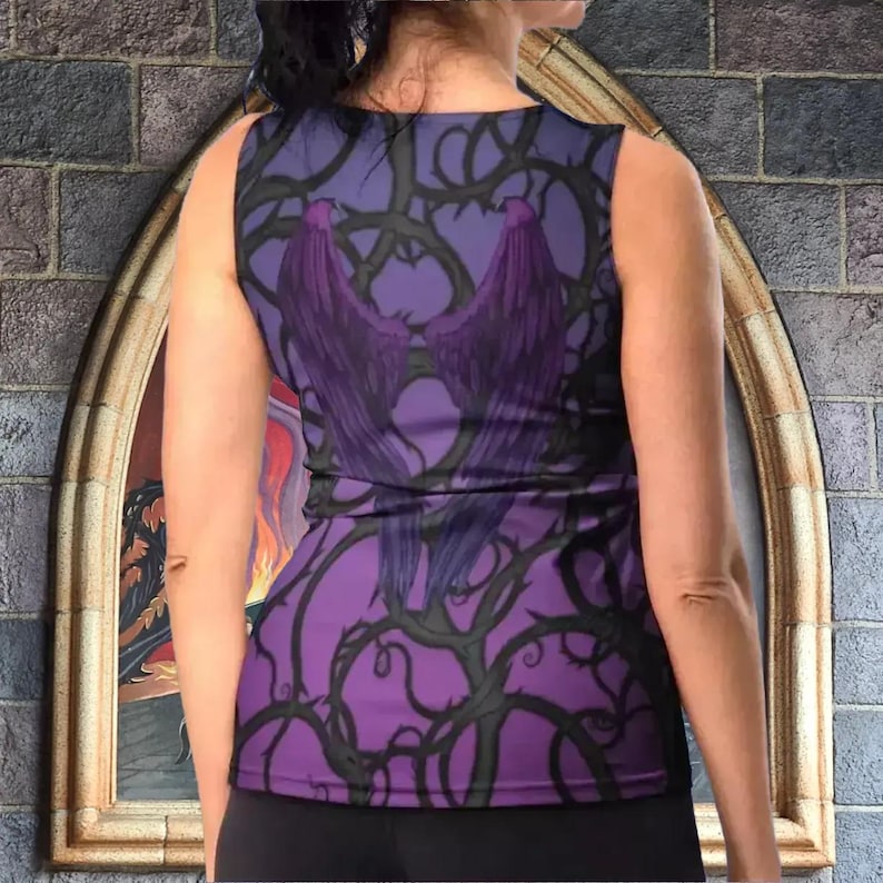 a woman wearing a purple top with a castle in the background