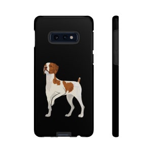 May include: Black phone case featuring an illustration of a white and brown Brittany dog.