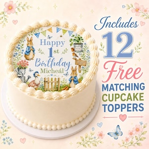 May include: A round cake with white frosting and a decorative topper featuring Peter Rabbit, a duck, a garden fence, and the text Happy 1st Birthday Micheál. The image includes text stating Includes 12 Free Matching Cupcake Toppers.