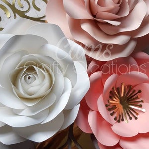 May include: Three large paper flowers in shades of pink and white. The flowers are layered and have a delicate, ruffled texture. The flowers are arranged on a white wooden background.