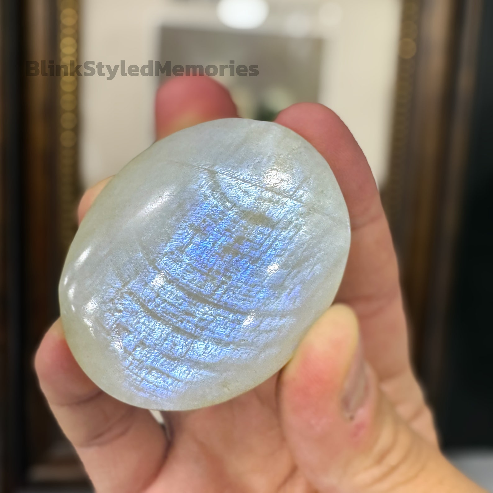 Polished rainbow moonstone palm stone with a soft blue flash, ideal for enhancing intuition and emotional healing in Cancer signs